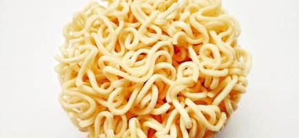 Uncooked instant noodles with negative space isolated on the gray white studio background. Food background design. Suitable for promotion of food and beverage industry and company, food advertising. photo