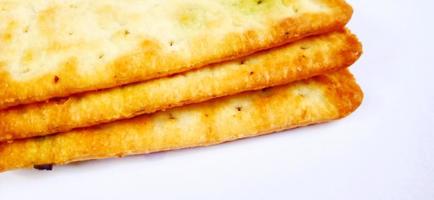 Sugarless and vegetable healthy cracker biscuit slices on the gray white studio background. Food background design. Suitable for promotion of food and beverage industry and company, food advertising. photo