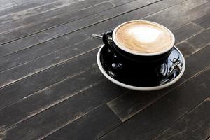 Hot coffee cup on a wooden table. photo