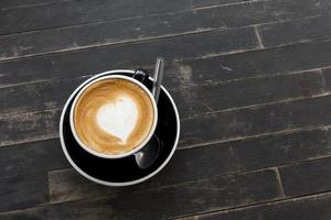 Hot coffee cup on a wooden table. photo