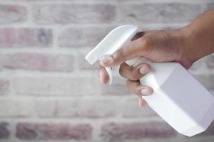 holding white color spray bottle with copy space photo