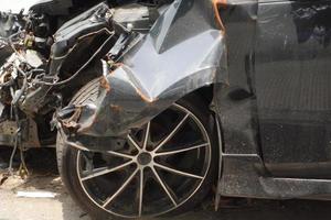 black car damaged by a road accident photo