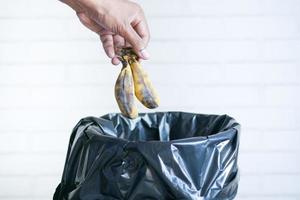 throwing banana in a garbage bin photo