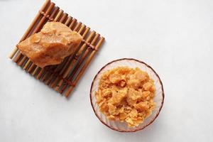 top view of jaggery traditional cane sugar cube on white background photo