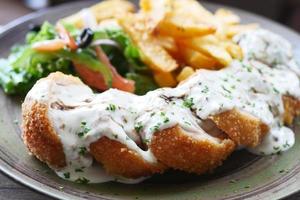 Chicken Cordon Bleu and Mayonnaise on table photo