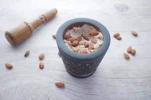 almond powder and almond in a jar on table, photo