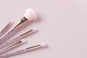 beauty brush on light pink background photo
