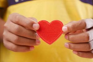 men holding red heart close up photo