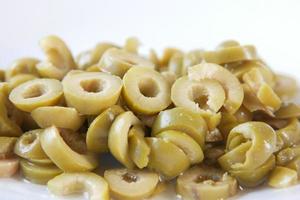close up of slice of olives on white background photo