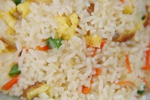 cooked fried rice in a bowl on table, close up, photo