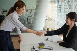 Guarantees, Mortgages, Signings, contract, agreement concept, Real estate agents shake hands with clients after signing the contract and congratulate them after reaching an agreement. photo