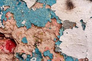 Texture of a concrete wall with cracks and scratches which can be used as a background photo