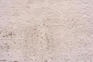 Texture of a concrete wall with cracks and scratches which can be used as a background photo