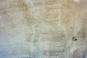 Texture of a concrete wall with cracks and scratches which can be used as a background photo