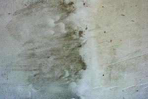 Texture of a concrete wall with cracks and scratches which can be used as a background photo