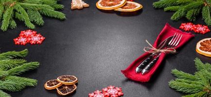 Festive Christmas table with appliances, gingerbreads, tree branches and dried citrus trees photo