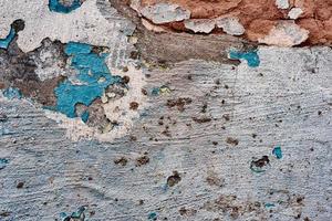 Texture of a concrete wall with cracks and scratches which can be used as a background photo
