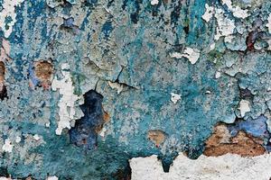 Texture of a concrete wall with cracks and scratches which can be used as a background photo