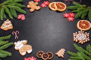 Festive Christmas table with appliances, gingerbreads, tree branches and dried citrus trees photo