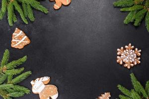 Festive Christmas table with appliances, gingerbreads, tree branches and dried citrus trees photo