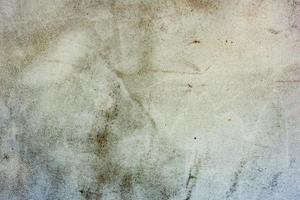 Texture of a concrete wall with cracks and scratches which can be used as a background photo