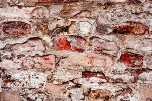 textura de una pared de ladrillo con grietas y arañazos que se pueden utilizar como fondo foto