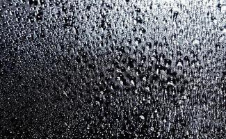 Dark shiny surface with droplets. Close up image of a wet surface. photo