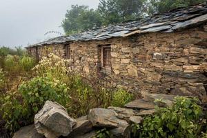 A traditional home in himalayan region of Uttarakhand India made of rocks. These small houses are also called CHANNI means house under stars. photo