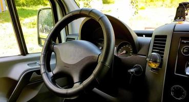 Close-up of the dashboard, speedometer, tachometer and steering wheel. Modern car interior. Internal cabin. Vehicle interior. Close shot of car dashboard. photo