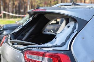 A car after an accident with a broken rear window. Broken window in a vehicle. The wreckage of the interior of a modern car after an accident, a detailed close-up view of the damaged car. photo