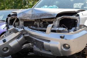 Traffic accident on the street, damaged car after a collision in the city. Accident due to speeding and alcohol intoxication. Transport background. The concept of road safety and insurance. photo