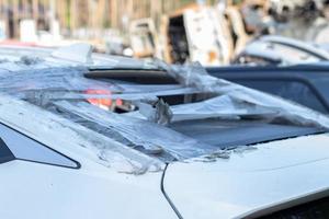 A car after an accident with a broken rear window. Broken window in a vehicle. The wreckage of the interior of a modern car after an accident, a detailed close-up view of the damaged car. photo