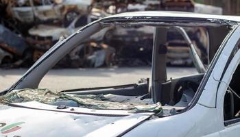 A car after an accident with a broken rear window. Broken window in a vehicle. The wreckage of the interior of a modern car after an accident, a detailed close-up view of the damaged car. photo