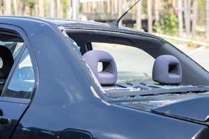 A car after an accident with a broken rear window. Broken window in a vehicle. The wreckage of the interior of a modern car after an accident, a detailed close-up view of the damaged car. photo