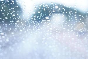 Blurred background of raindrops on the car windshield photo