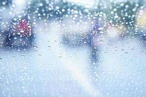 Blurred background of raindrops on the car windshield photo