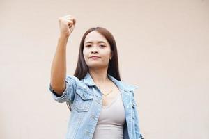 Asian woman holding up two fingers photo