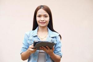 Asian women happily use portable computers. because the operating results are more profitable photo