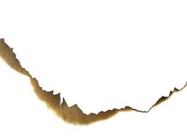 Hole paper with burned edges on white background photo