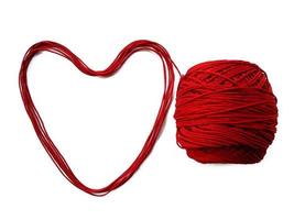 Knitting yarn heart shaped isolated on white background photo