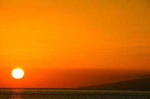 Colorful sunset over water photo