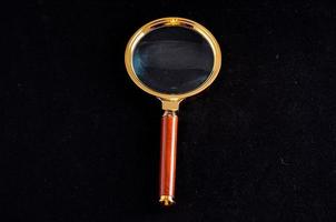 Magnifying glass on black photo