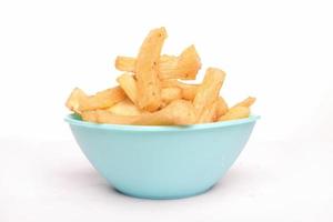 front view of fried cassava in a blue bowl on a white background, copy space, texture, Indonesian food. clipping path photo