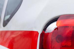 The rear left lamp of a white car is broken. The taillight of the car was shattered in the accident. Damage accident. Security concept. Rear stop of a car in an accident close-up. photo