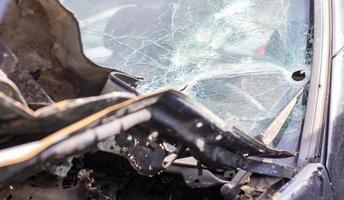 Holes on the windshield of the car, it was shot from a firearm. Bullet holes. Smash car windshield, broken and damaged car. The bullet made a cracked hole in the glass. photo