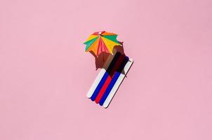 Colorful beach towels with sun umbrellas on pink sand beach. photo