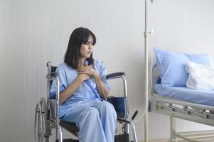 A despondent Asian woman patient. Following the doctor's declaration that the cancer was nearing the end of its course. photo