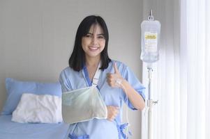 Hopeful and happy young patient woman in hospital, healthcare and medical concept photo