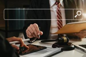 Searching Browsing Internet Data Information Networking Concept with blank search bar.justice and law concept.Male judge in a courtroom with the gavel,working with digital tablet computer. photo