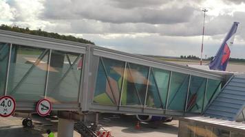 Passengers boarding the airliner through jet bridge video